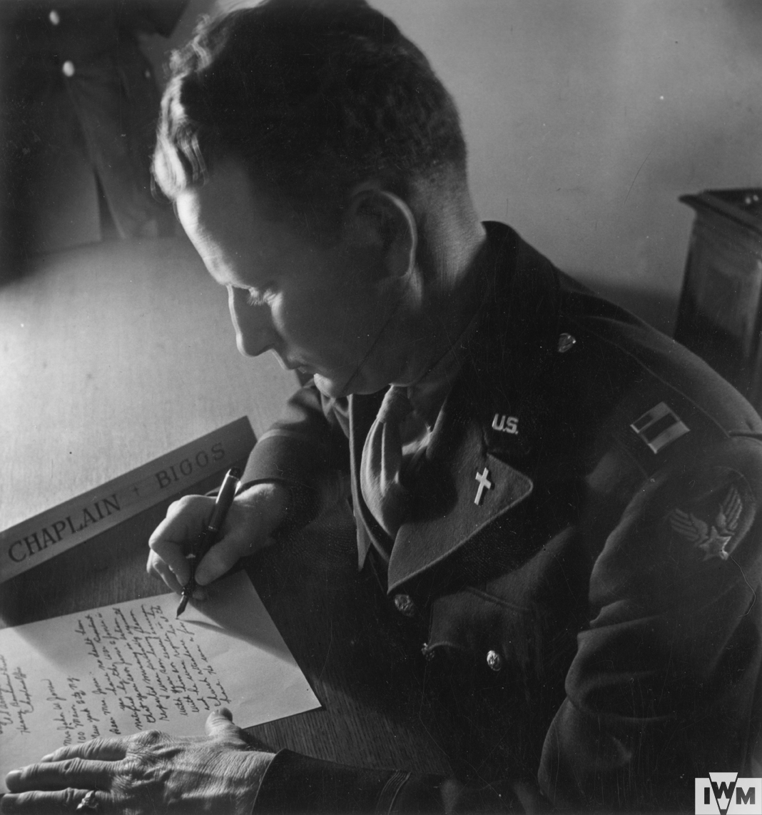 Captain Chaplain Biggs of the 91st Bomb Group writes a letter to the family of an airman who did not return from a mission. 